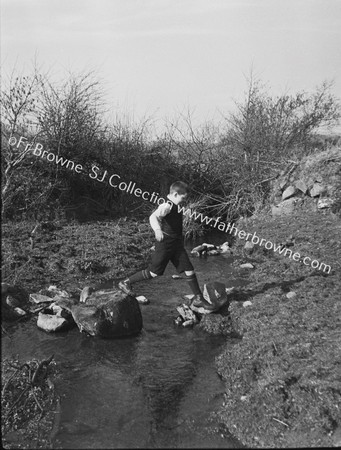 BOY ON STEPPING STONES